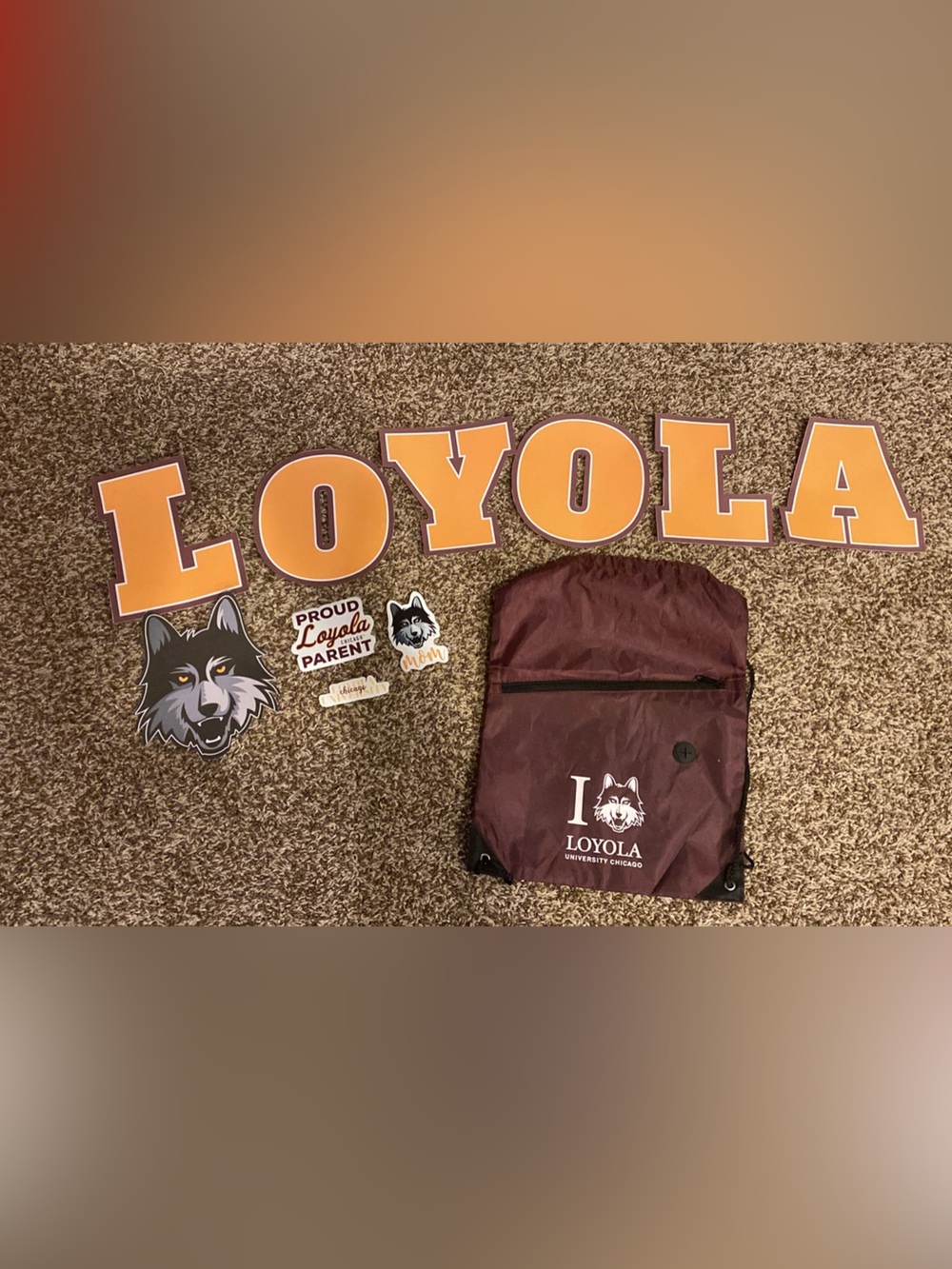 Loyola Maroon Drawstring Backpack with Loyola Wolf Logo and stickers
